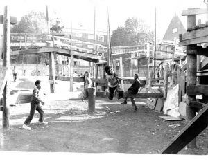 Where is the Gaiety? Still Images. Notting Hill Gate. Inside the Adventure Playground. 1973. Child on rope swing looking to camera 4. Deposited with MayDay Rooms by Wilf Thust. December, 2013.