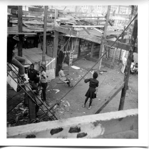 Where is the Gaiety? Still Images. Notting Hill Gate. Inside the Adventure Playground. 1973. Children sitting on swing ropes 3. Deposited with MayDay Rooms by Wilf Thust. December, 2013.