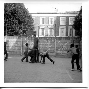 Where is the Gaiety? Still Images. Notting Hill Gate. Inside the Adventure Playground. 1973. Play ‘leader’ with children 3. Deposited with MayDay Rooms by Wilf Thust. December, 2013.